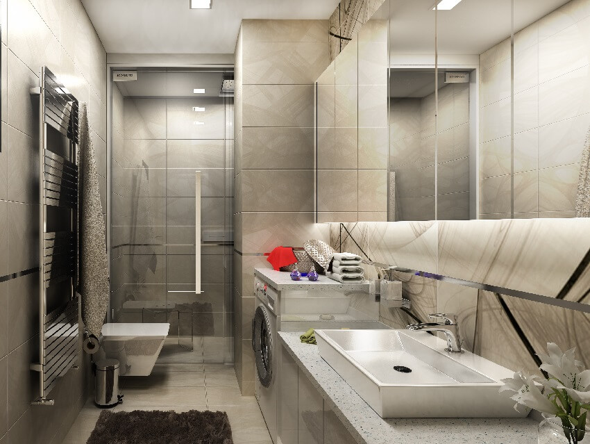 Серый кафельный интерьер ванной комнаты с туалетом, раковиной, стиральной машиной, сушилкой и душем со стеклянными дверями и кафельным потолком