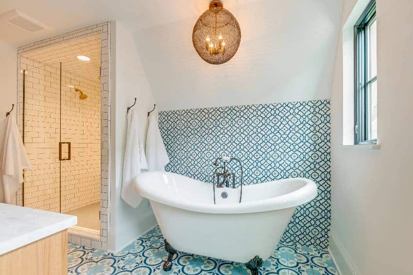 Акцентная стена ванной комнаты с сине-белой плиткой и отдельно стоящей ванной