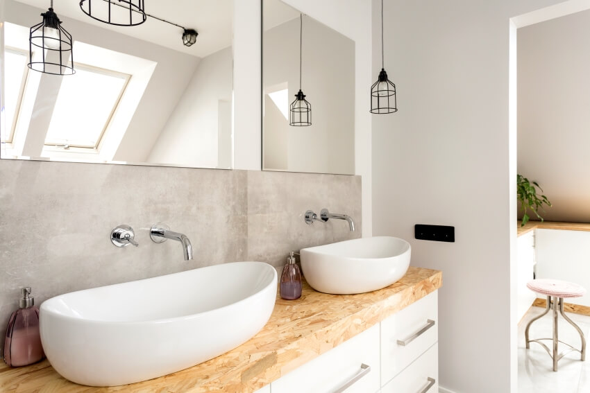 Минималистская ванная комната с двумя раковинами на деревянной столешнице и подвесными светильниками