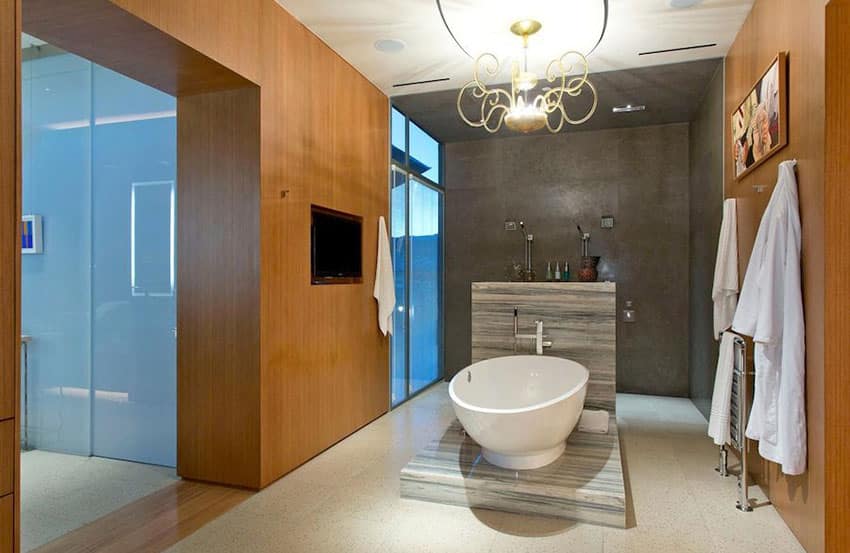 Современная ванная комната с отдельно стоящей ванной и золотой люстрой