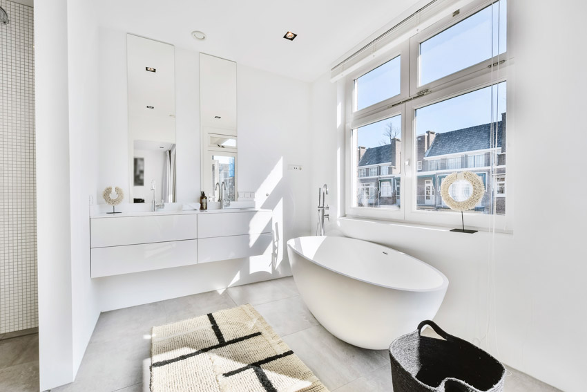 Яркая и красивая ванная комната с акриловой ванной, окнами, зеркалом и потолочными светильниками