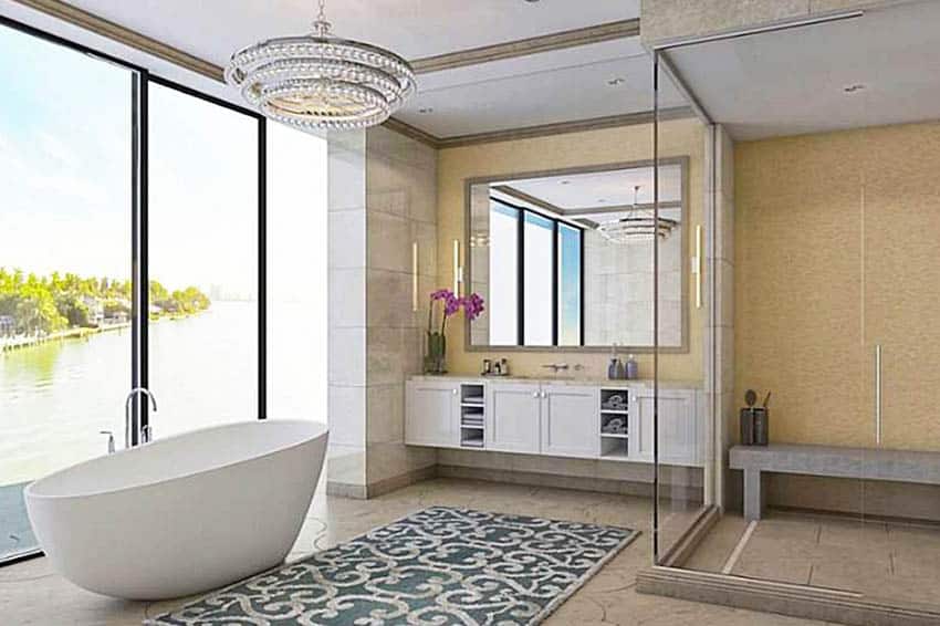 Роскошная современная ванная комната со стеклянным душем и каменной скамейкой с видом на воду