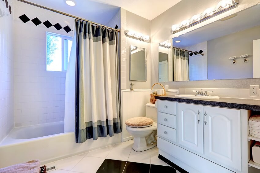 Refreshing bright bathroom with white cabinet bath tub and white curtain